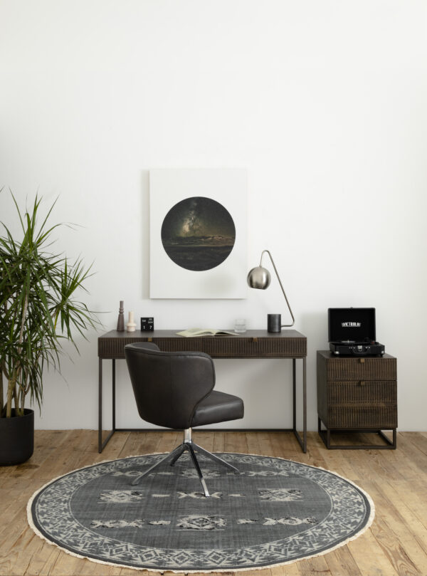 A study table, chair, lamp, and side table in a room