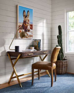 Wood study table, chair, painting, and a plant in a room